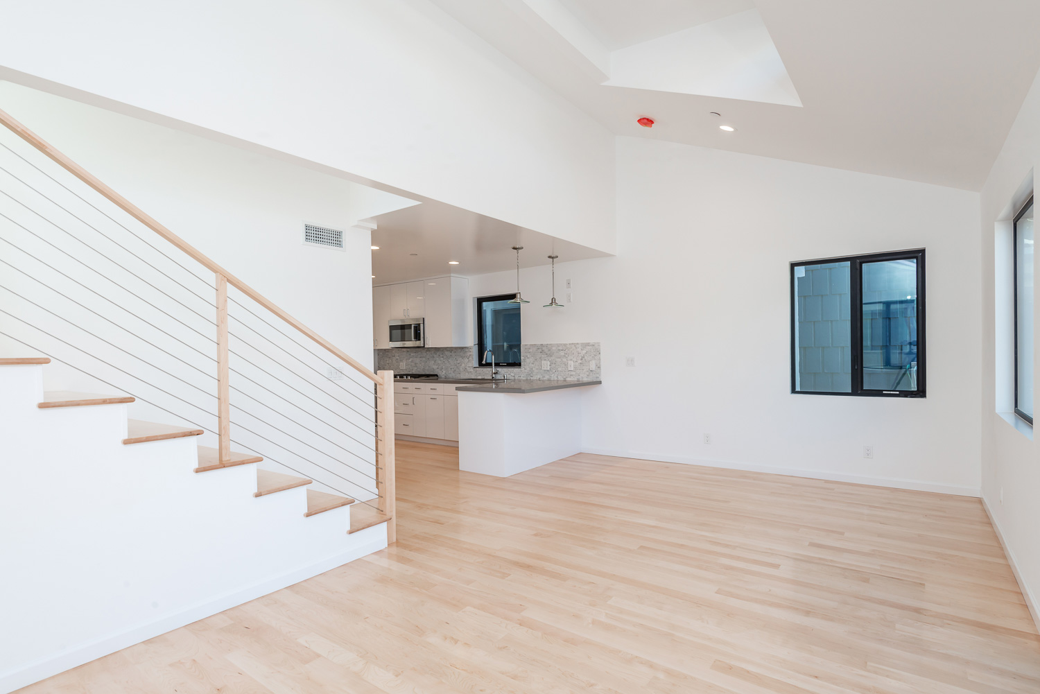 Interior Photo of a real estate residential home with wood flooring and white walls